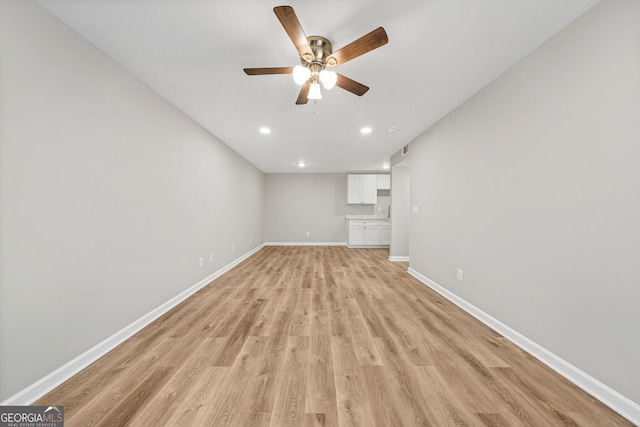 unfurnished living room featuring light hardwood / wood-style floors and ceiling fan