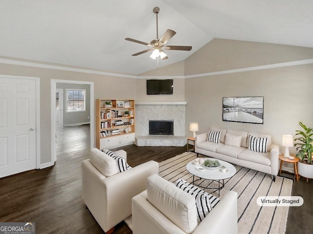 living room featuring ceiling fan, a fireplace, dark hardwood / wood-style floors, and vaulted ceiling