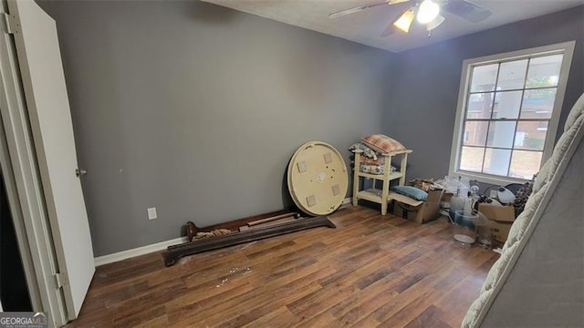 miscellaneous room featuring dark wood-type flooring and ceiling fan