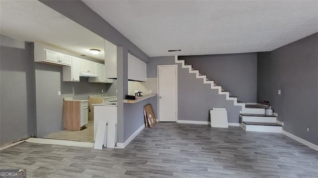 kitchen featuring light hardwood / wood-style floors and white cabinets