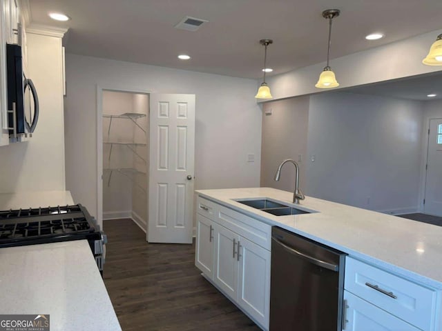 kitchen with dark wood-type flooring, sink, decorative light fixtures, dishwasher, and white cabinets