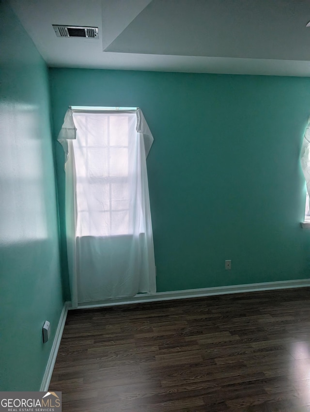 unfurnished room featuring dark hardwood / wood-style floors