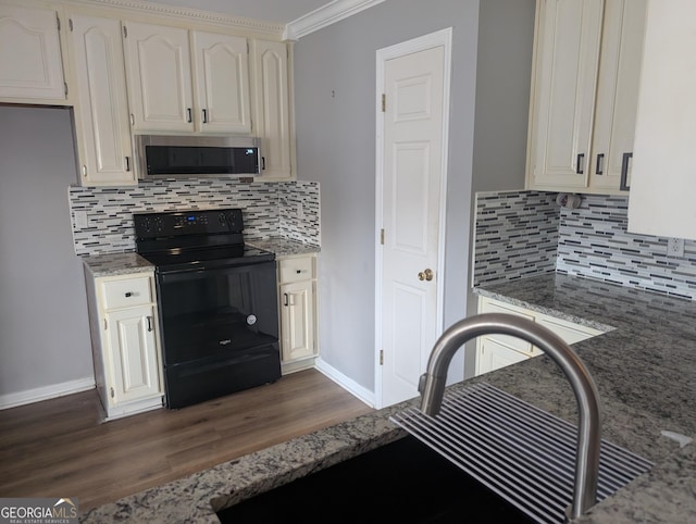 kitchen with dark wood-type flooring, sink, black / electric stove, light stone countertops, and backsplash