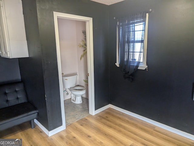 bathroom with toilet and hardwood / wood-style floors