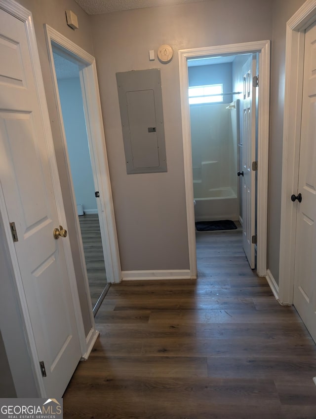 hall with dark wood-type flooring and electric panel