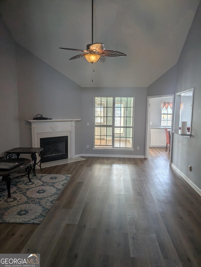 unfurnished living room with hardwood / wood-style floors, high vaulted ceiling, and ceiling fan