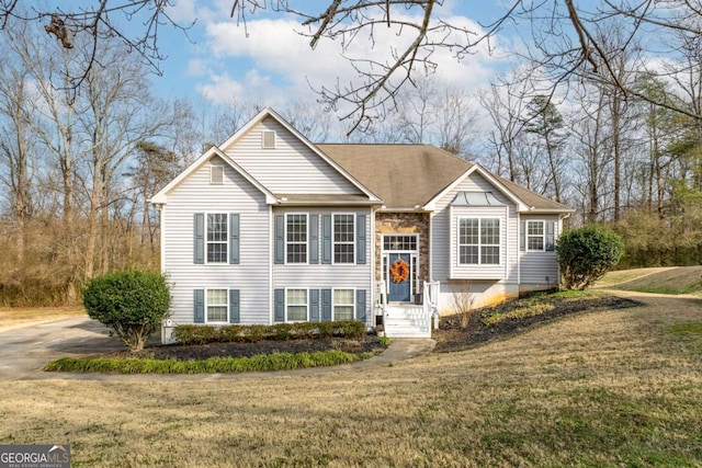 split foyer home with a front lawn