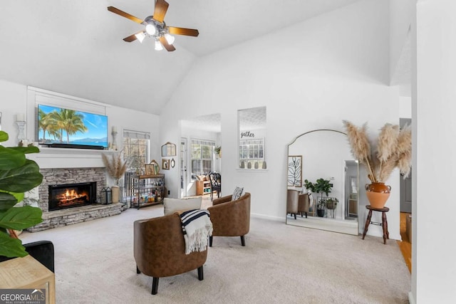 carpeted living room with a fireplace, high vaulted ceiling, and ceiling fan