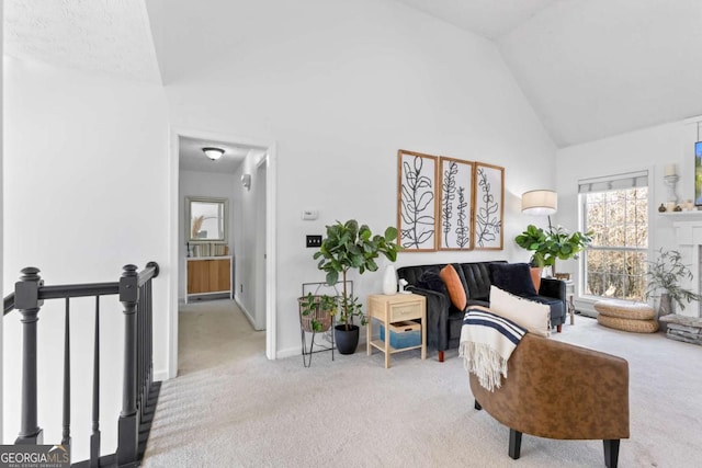 living area with carpet floors and high vaulted ceiling