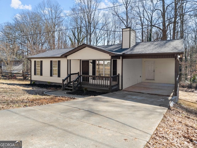 ranch-style home featuring a carport and a porch