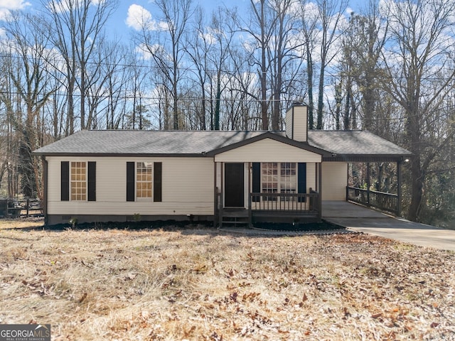 ranch-style house featuring a carport and a porch