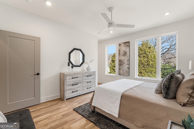 bedroom with ceiling fan and light hardwood / wood-style floors