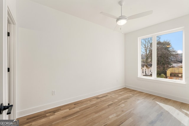 unfurnished room featuring ceiling fan and light wood-type flooring