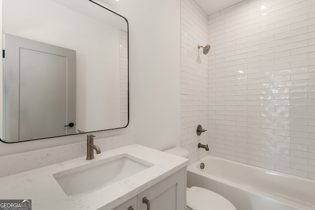 full bathroom with tiled shower / bath combo, vanity, and toilet