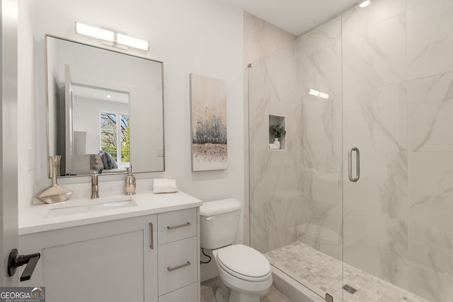 bathroom with vanity, toilet, and an enclosed shower