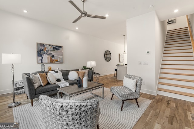 living room with ceiling fan and wood-type flooring