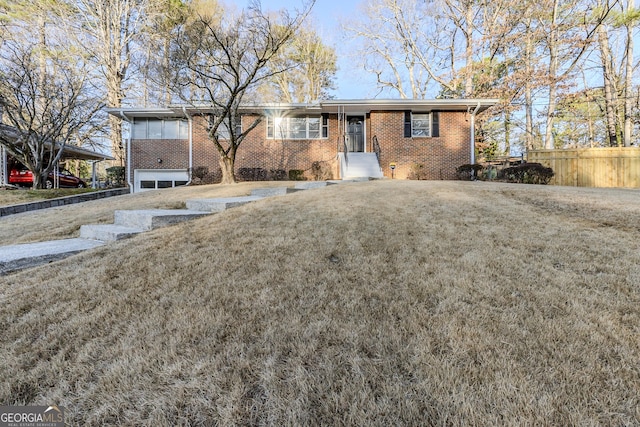 ranch-style home featuring a carport, a garage, and a front lawn