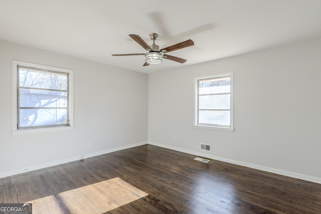 empty room featuring dark hardwood / wood-style flooring and ceiling fan