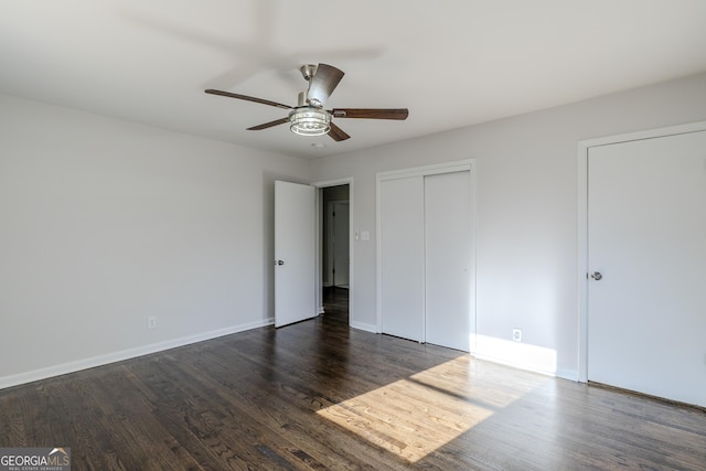 unfurnished bedroom featuring a closet, dark hardwood / wood-style floors, and ceiling fan