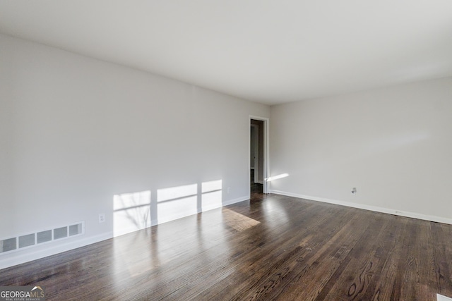 spare room featuring dark hardwood / wood-style floors