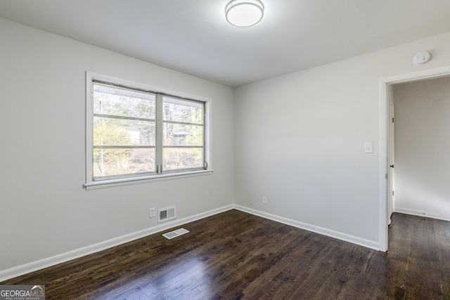 unfurnished room featuring dark hardwood / wood-style floors