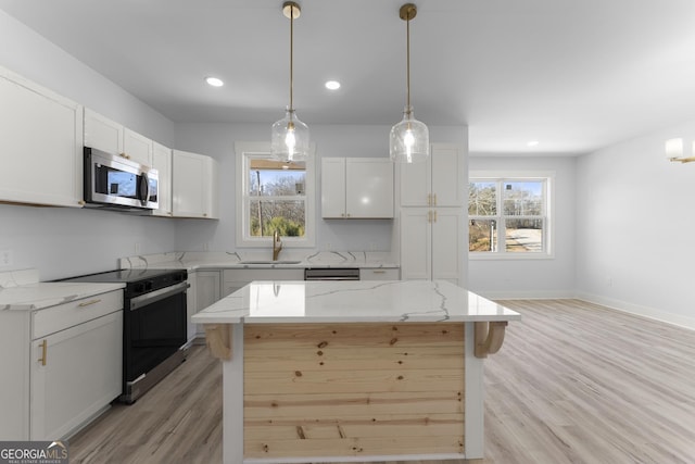 kitchen with white cabinetry, sink, range with electric cooktop, and a center island