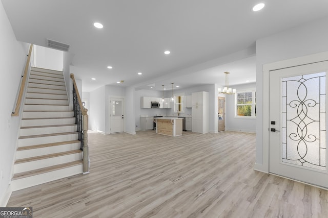 entryway featuring a notable chandelier and light wood-type flooring