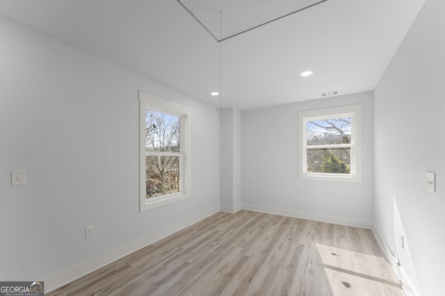 empty room with light hardwood / wood-style floors