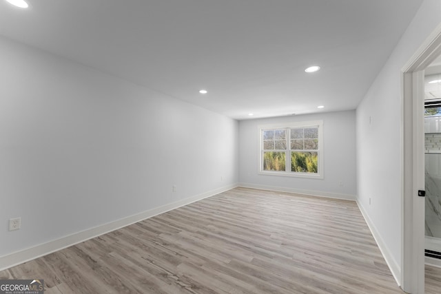 unfurnished room with light hardwood / wood-style floors