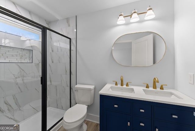 bathroom featuring vanity, hardwood / wood-style flooring, a shower with shower door, and toilet