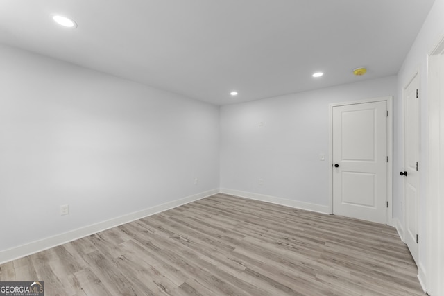 spare room with light hardwood / wood-style flooring