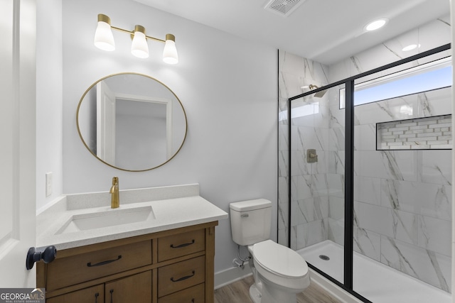 bathroom featuring hardwood / wood-style floors, vanity, toilet, and walk in shower