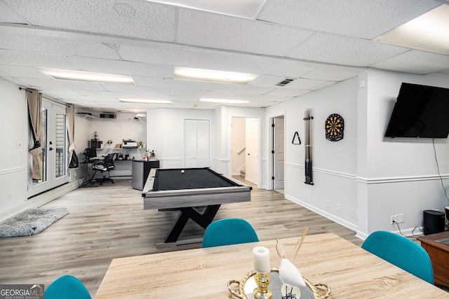 game room featuring a drop ceiling, light wood-type flooring, and billiards