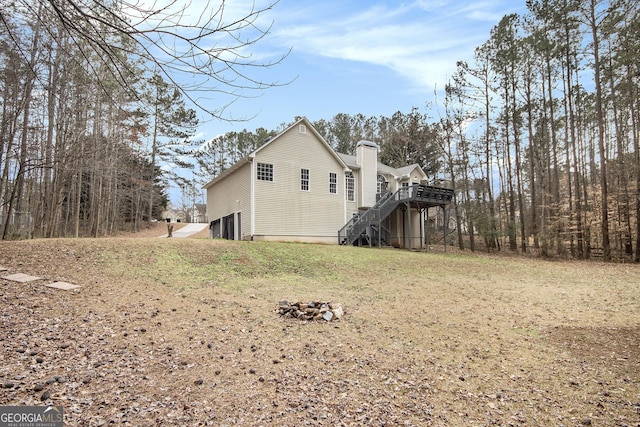 view of side of property with a yard and a deck