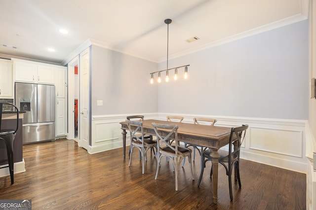 dining space featuring ornamental molding and dark hardwood / wood-style floors