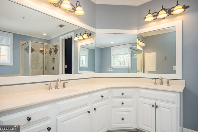 bathroom featuring vanity, plenty of natural light, ornamental molding, and a shower with shower door