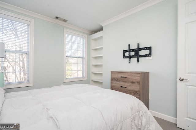 bedroom with crown molding and carpet