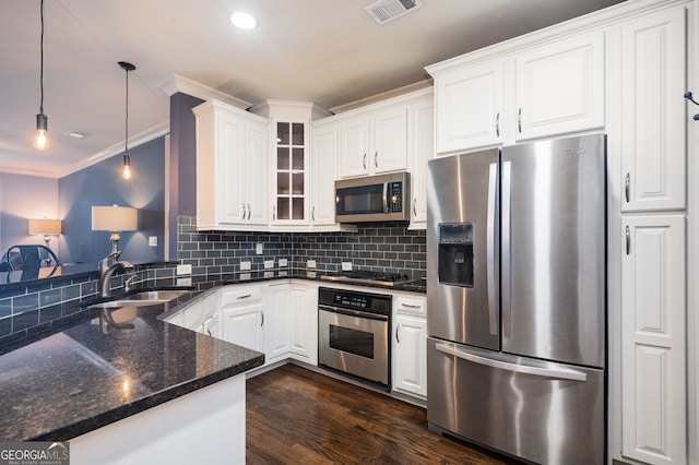 kitchen featuring hanging light fixtures, white cabinetry, appliances with stainless steel finishes, and sink