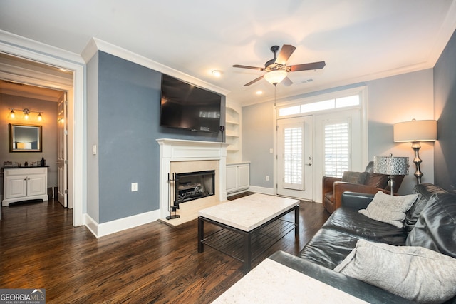 living room featuring crown molding, ceiling fan, and dark hardwood / wood-style flooring