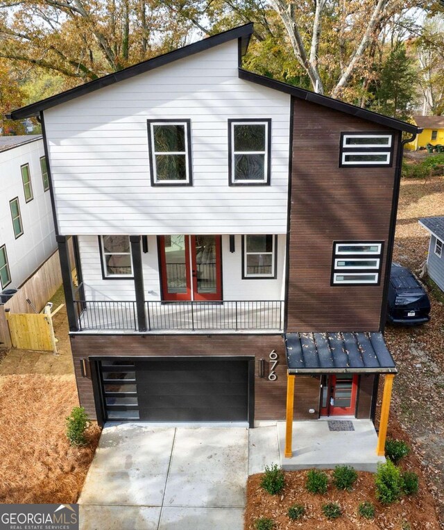 view of front of property featuring a garage and a porch