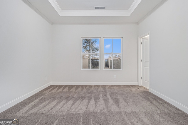 carpeted empty room featuring ornamental molding and a tray ceiling