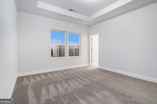 unfurnished room with carpet flooring, ornamental molding, and a tray ceiling