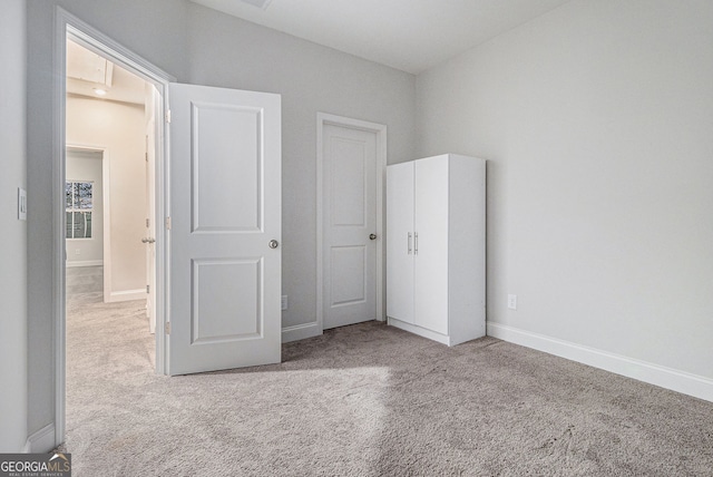 unfurnished bedroom with light colored carpet