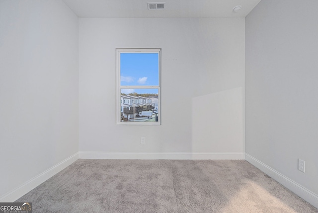 empty room featuring light carpet