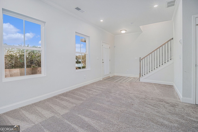 unfurnished room with light colored carpet and ornamental molding