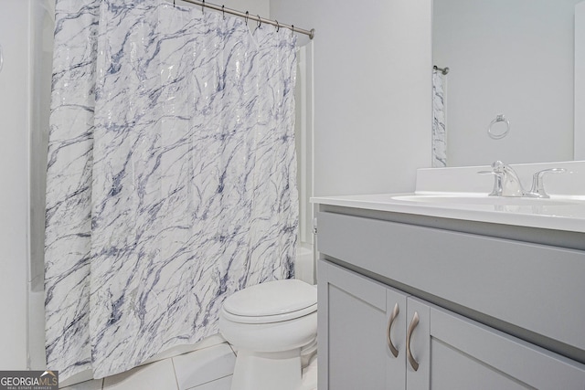 bathroom featuring vanity, toilet, and tile patterned flooring