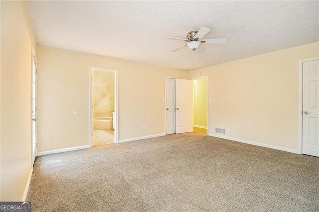 spare room featuring a textured ceiling, ceiling fan, and carpet flooring