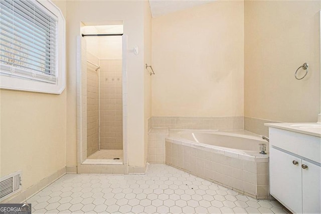 bathroom with vanity, tile patterned floors, and shower with separate bathtub