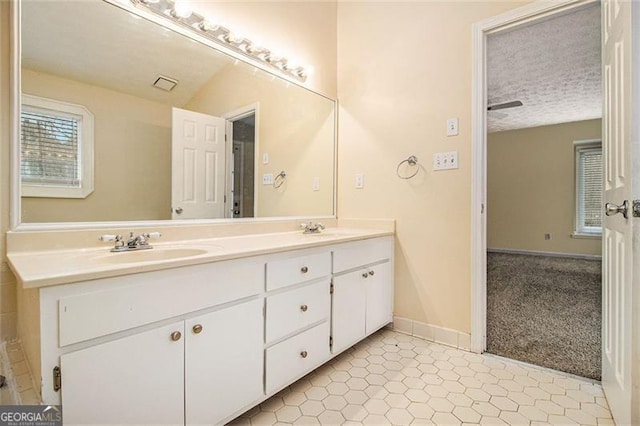 bathroom featuring vanity and a textured ceiling