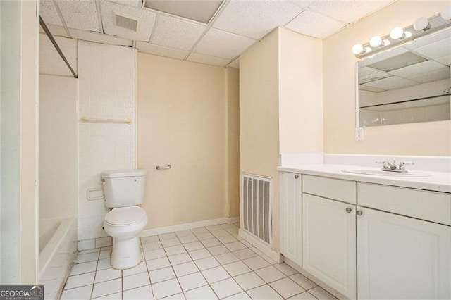 bathroom featuring a paneled ceiling, vanity, toilet, and tile patterned flooring